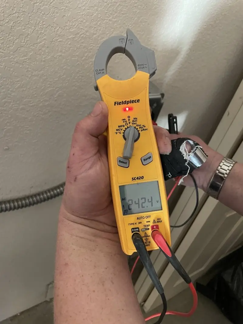 Voltage testing with clamp meter during Recessed Lighting Installation in Lutherville